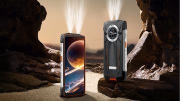 Two smartphones, one with a space-themed display and the other with a rugged design, on a rocky surface.